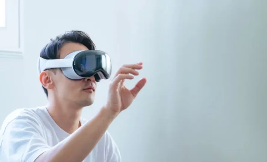 Man using a VR headset in a bright room.